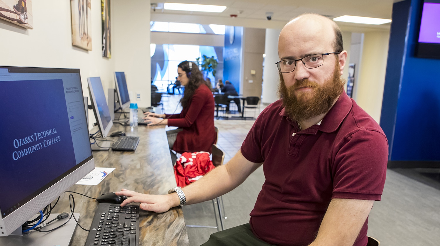 OTC student Kit Gillihan sits at a computer