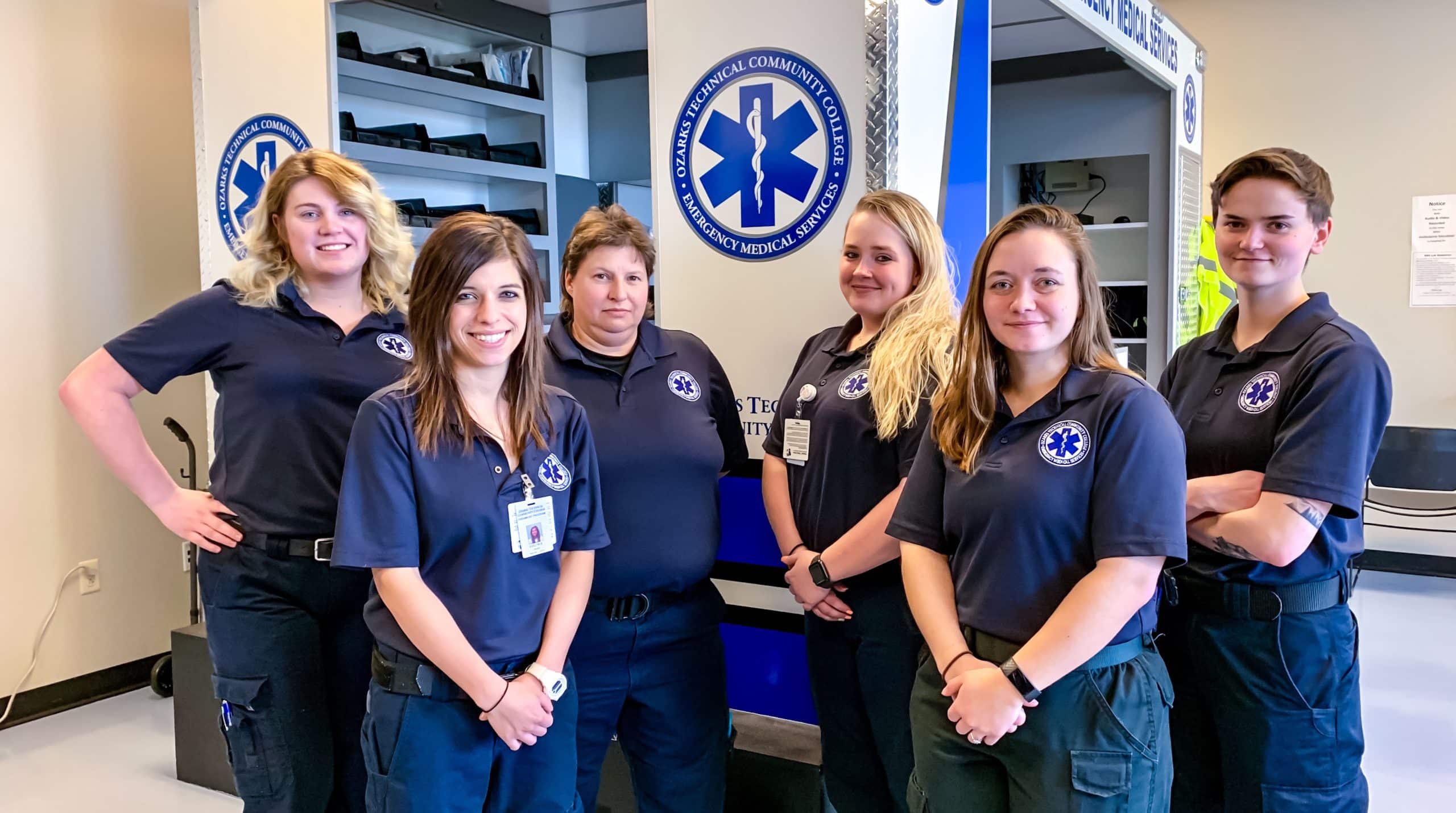 OTC paramedic students pose in front of an ambulance