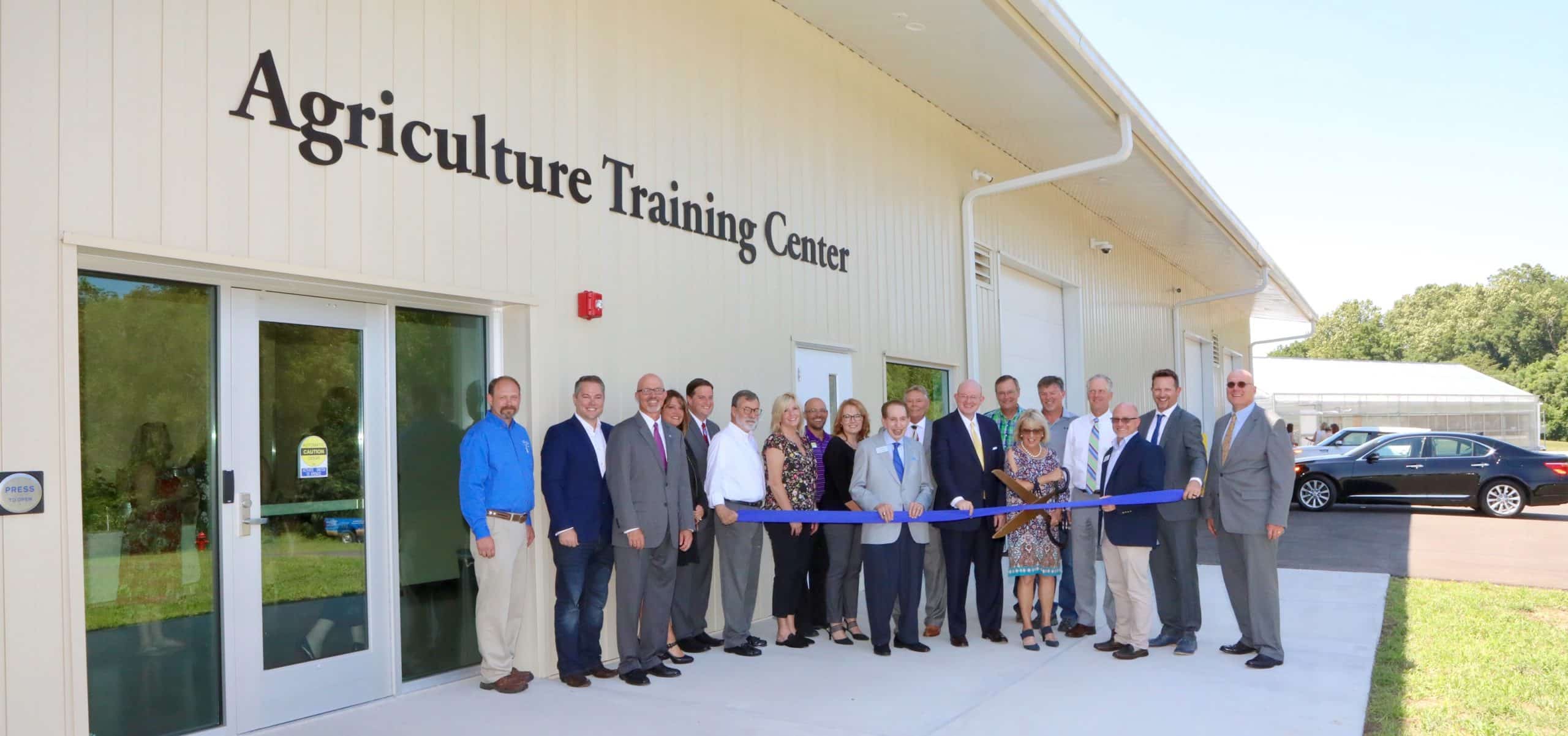 OTC officials and community partners cut the ribbon in front of the Agriculture Training Center at Richwood Valley