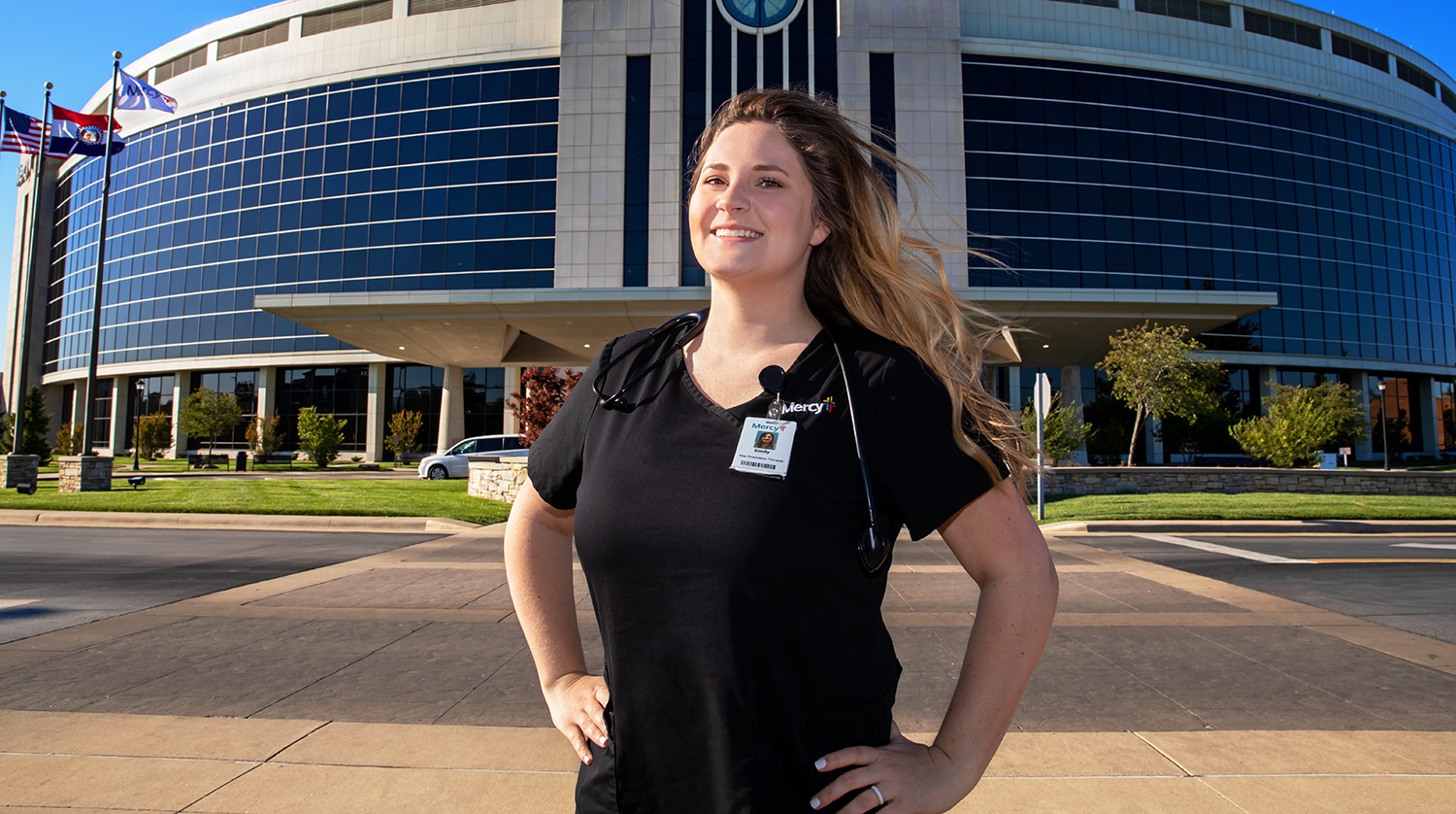 Emily Dye, a graduate of the OTC Respiratory Therapy Program, stands confidently in front of Mercy Hospital where she is employed.