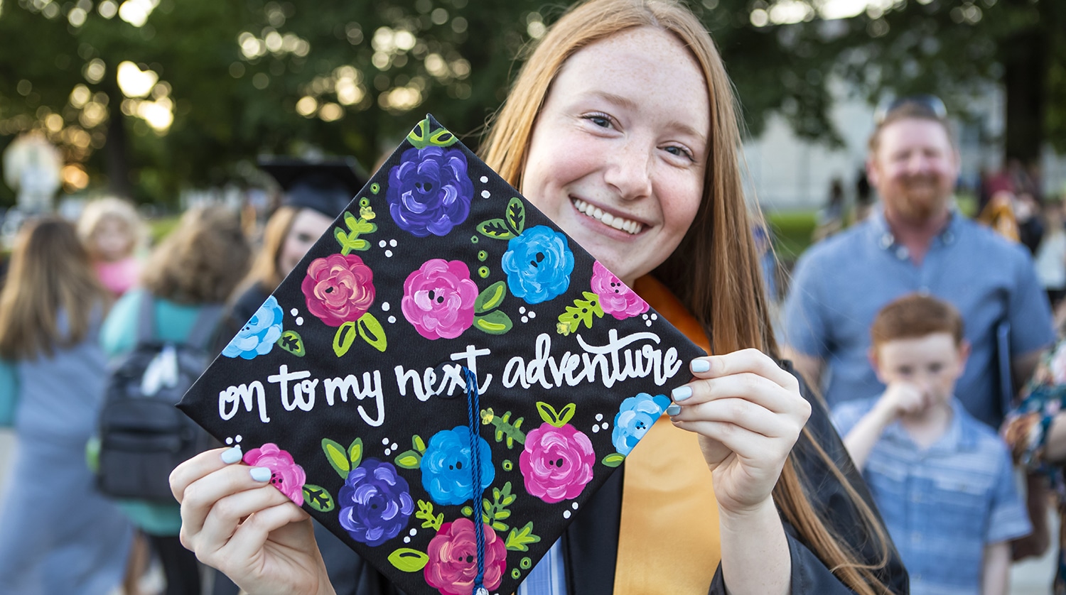 OTC graduate displays decorated mortar board at commencement