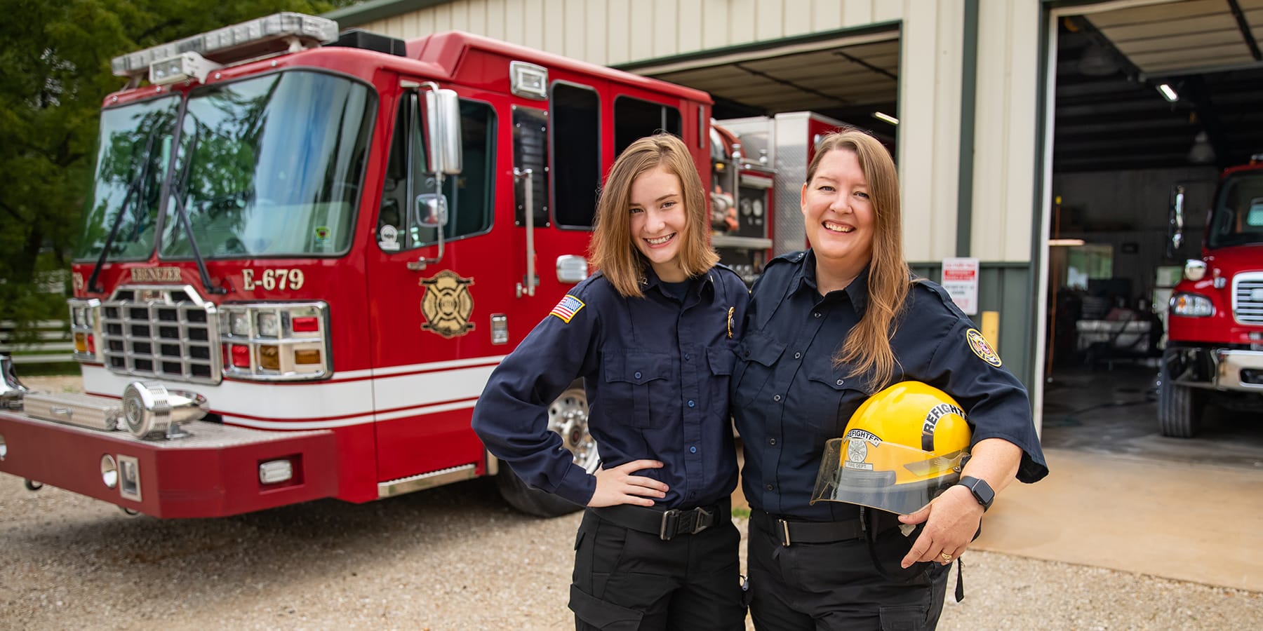 Andrea and Karleigh Lane, OTC Fire Science and EMT students stand outside Ebenezer Fire Department were they are both employed.