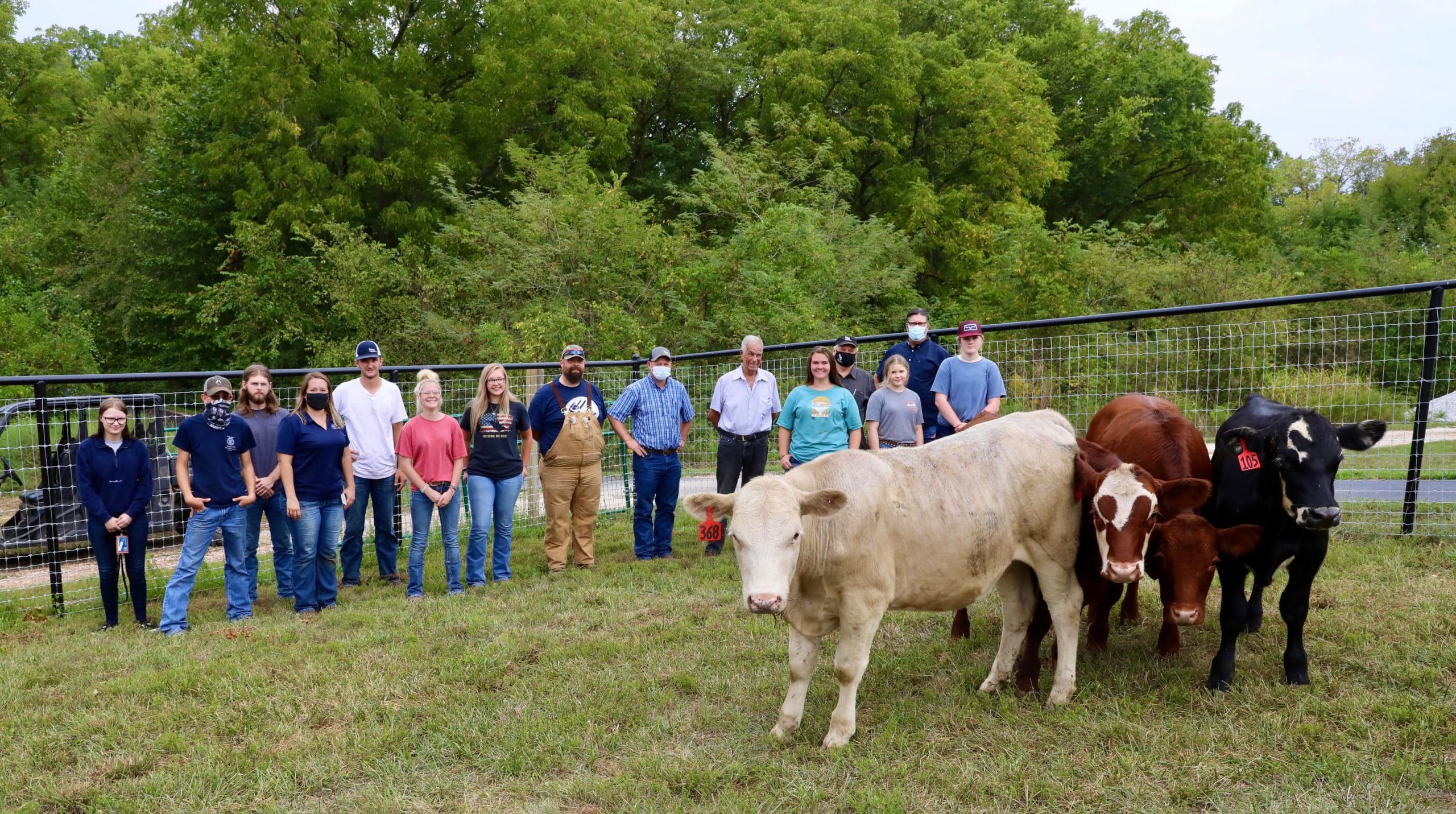 OTC ag students and instructors pose with the donated steers