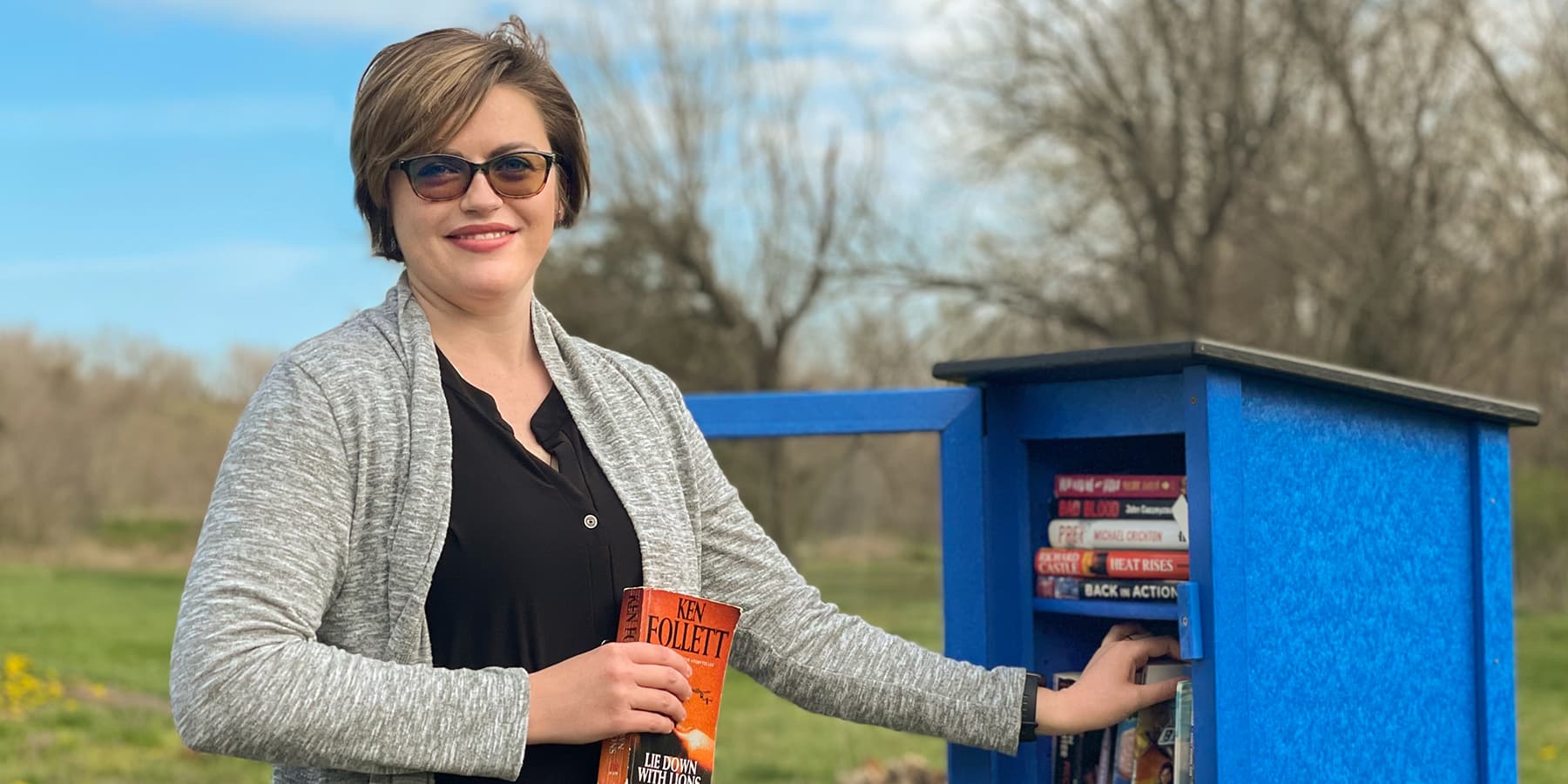 Alisha Byers stocks the shelves of OTC's Little Free Library