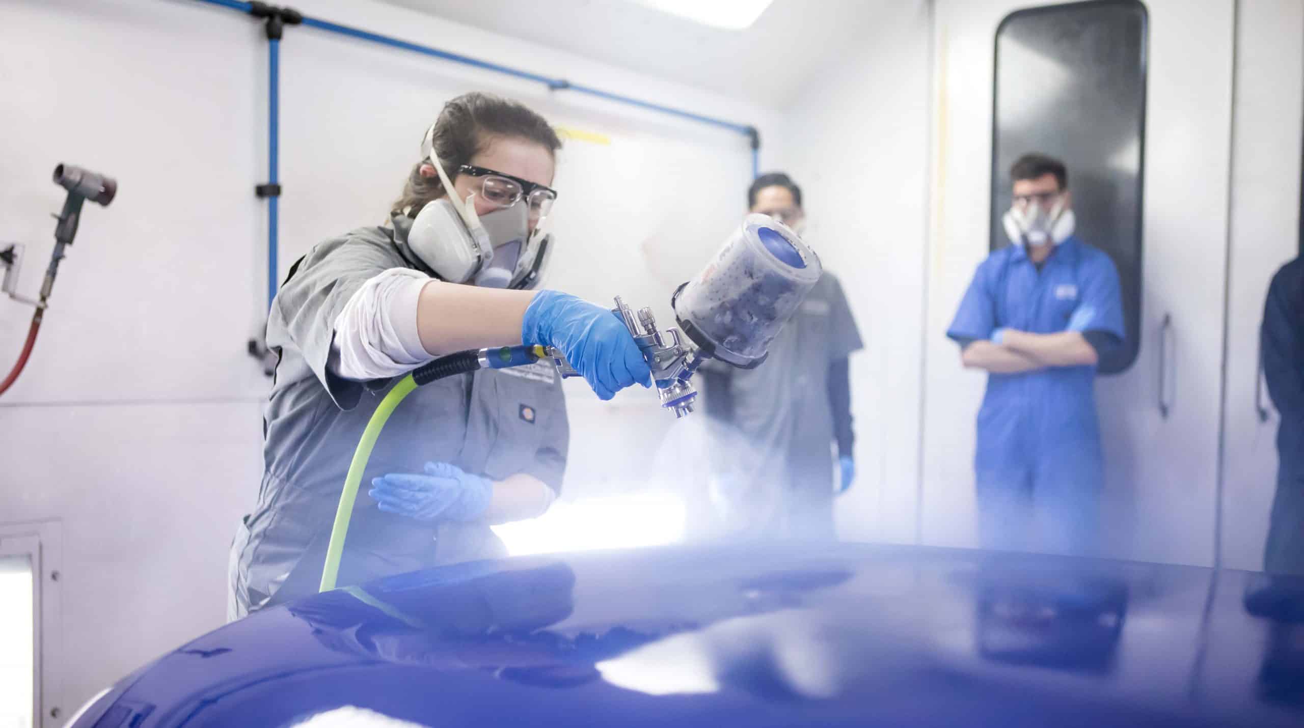 OTC student refinishes the hood of a car