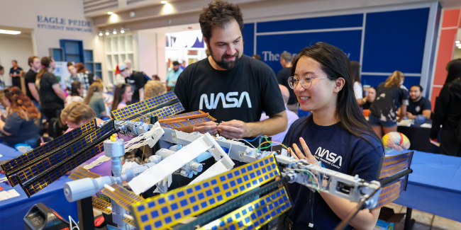 Ozarks Tech SED Space Techs NASA ISS Model Ozarks Tech students Billy Rice and Emily Zimmerman display a model of NASA's International Space Station.