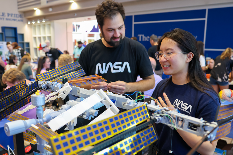 Ozarks Tech SED Space Techs NASA ISS Model Ozarks Tech students Billy Rice and Emily Zimmerman display a model of NASA's International Space Station.